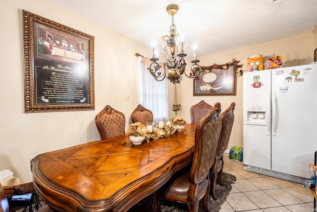 tiled dining area with a textured ceiling and an inviting chandelier