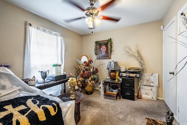 bedroom featuring a textured ceiling, carpet flooring, and ceiling fan