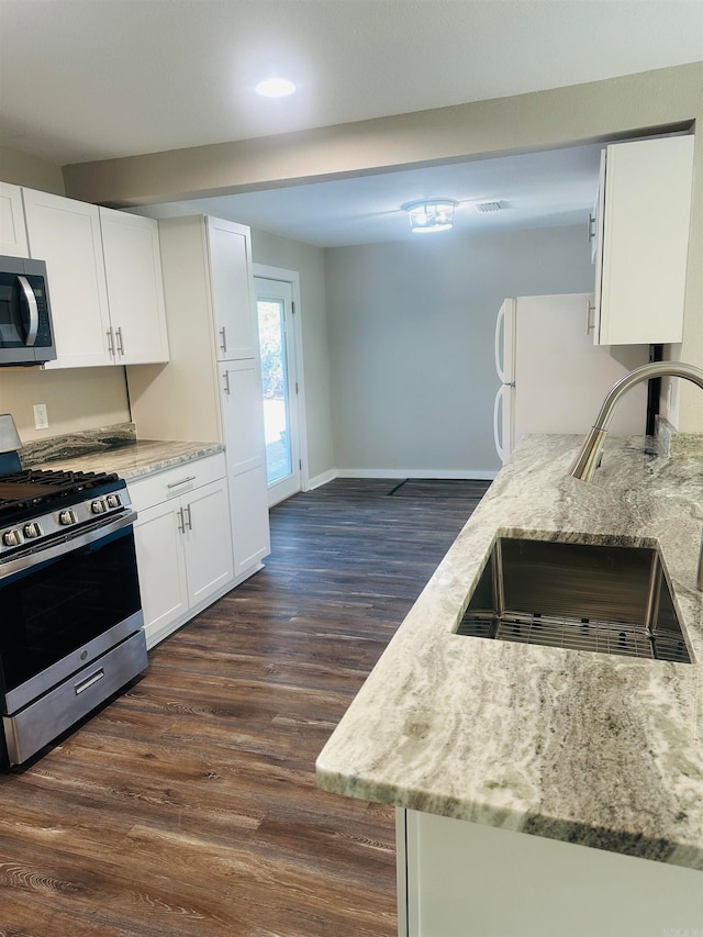 kitchen featuring white cabinetry, stainless steel appliances, sink, and dark hardwood / wood-style flooring