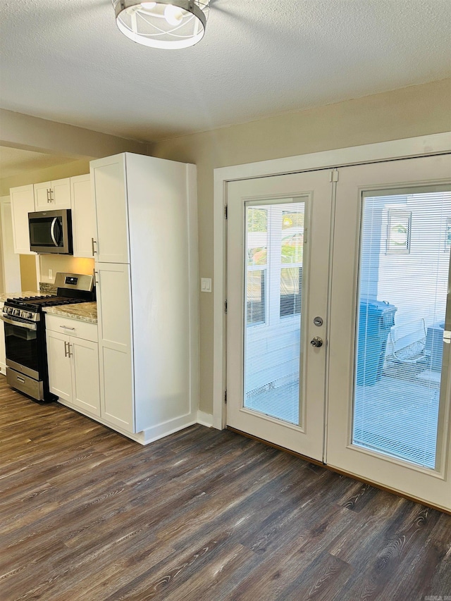 doorway to outside with french doors, a textured ceiling, and dark hardwood / wood-style flooring