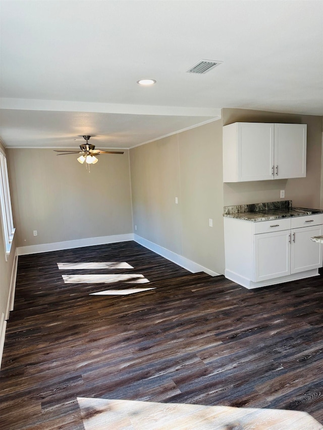 unfurnished living room with ceiling fan and dark hardwood / wood-style flooring