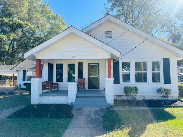 view of front of house with a front lawn and a porch