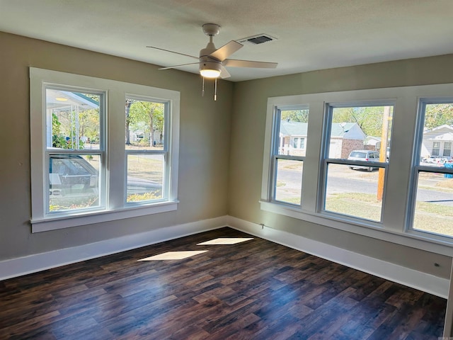 spare room featuring dark hardwood / wood-style floors and ceiling fan