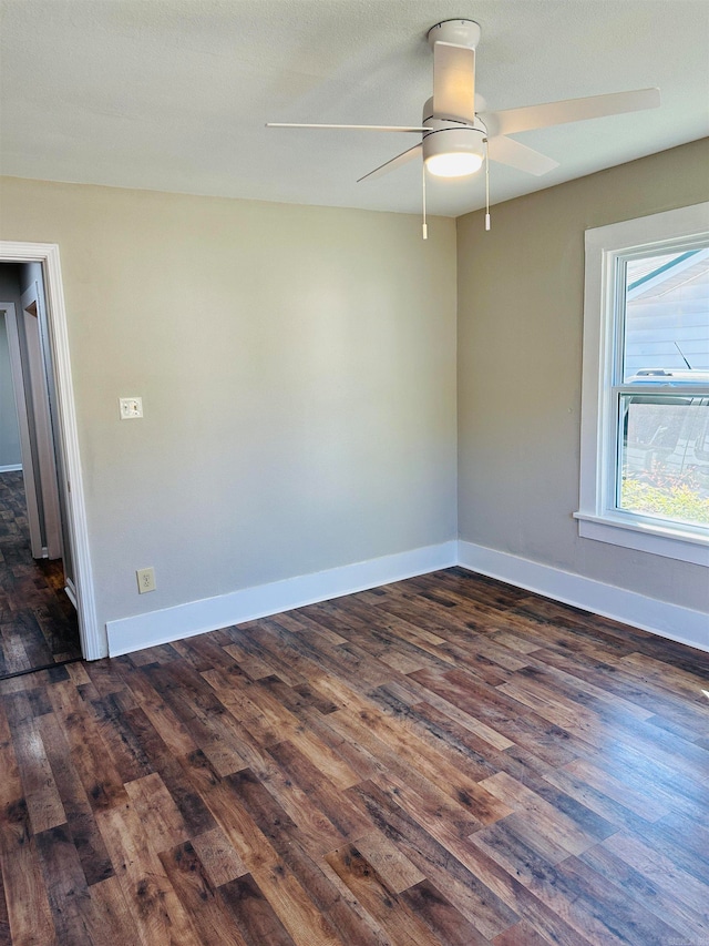 unfurnished room with ceiling fan, a textured ceiling, and dark hardwood / wood-style flooring