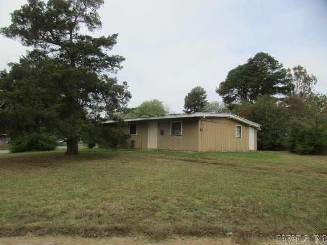 view of home's exterior with a lawn