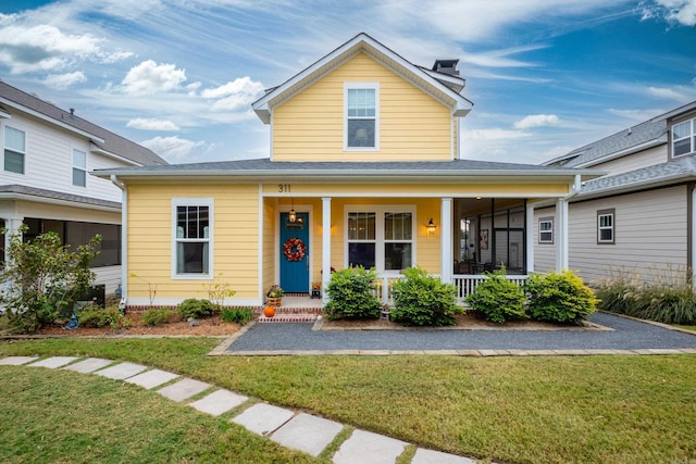 view of front facade with a front lawn and a porch