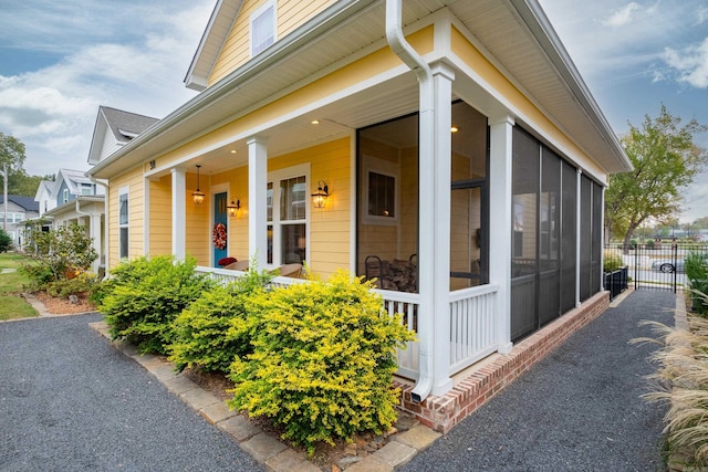 view of side of property with a sunroom