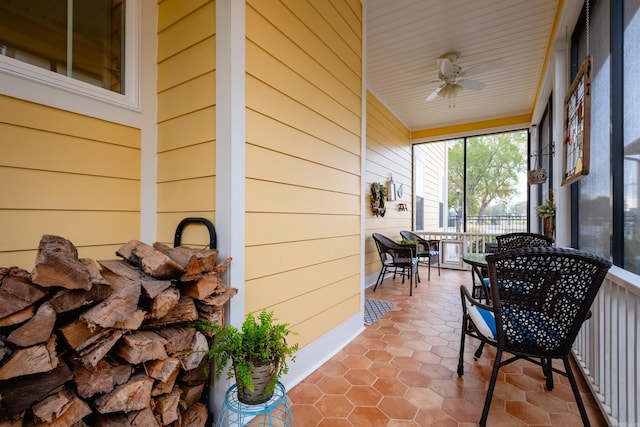 sunroom / solarium featuring ceiling fan