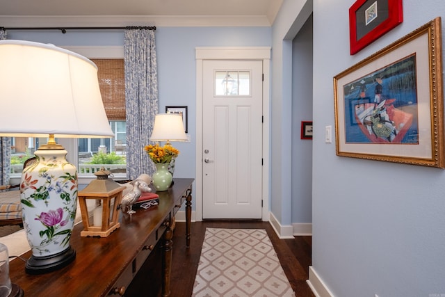 entryway featuring ornamental molding and dark hardwood / wood-style floors