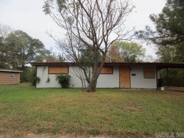 rear view of house featuring a yard