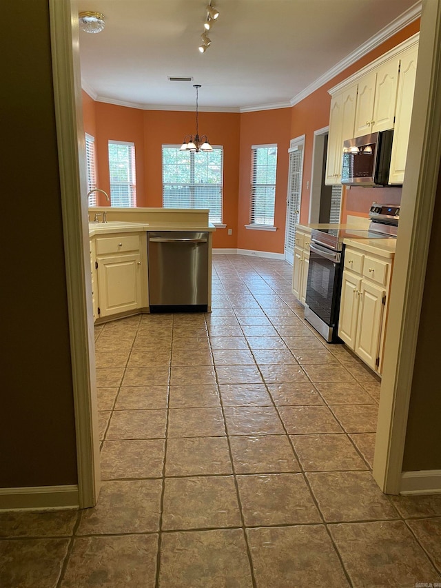 kitchen featuring stainless steel appliances, light tile patterned flooring, pendant lighting, and crown molding