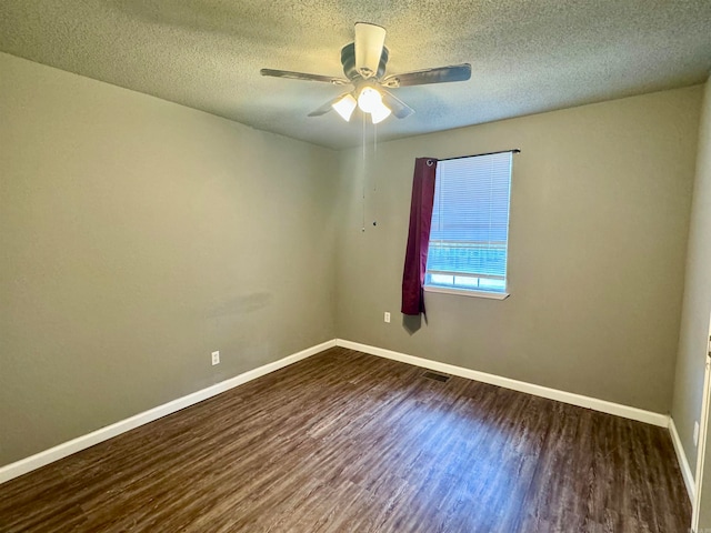 empty room with ceiling fan, a textured ceiling, and dark hardwood / wood-style flooring