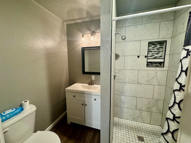 bathroom featuring vanity, wood-type flooring, a shower with curtain, and toilet