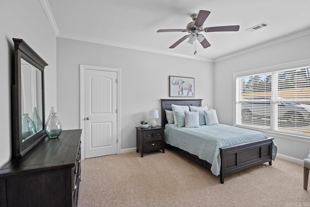 carpeted bedroom featuring crown molding and ceiling fan