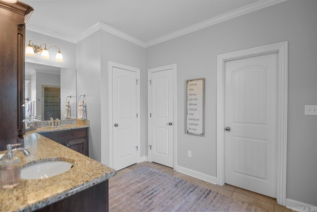 bathroom featuring vanity, crown molding, and tile patterned flooring