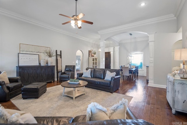 living room featuring ornamental molding, decorative columns, dark hardwood / wood-style floors, and ceiling fan