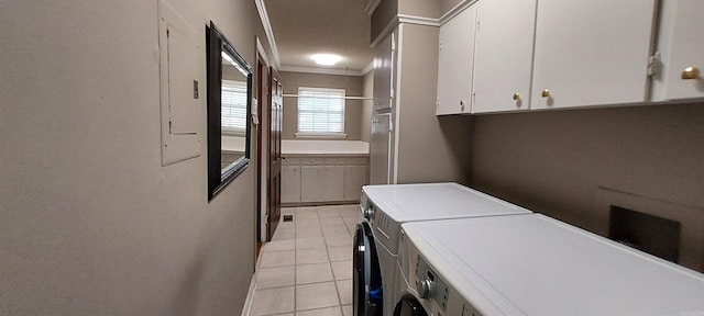 clothes washing area with crown molding, light tile patterned flooring, and independent washer and dryer