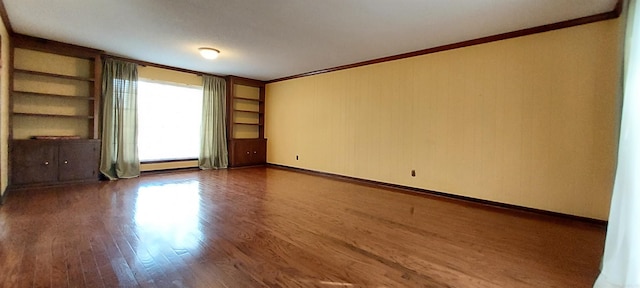 unfurnished living room featuring crown molding, a baseboard heating unit, and dark hardwood / wood-style floors