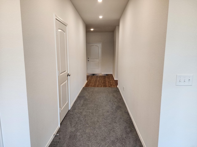 corridor with dark colored carpet