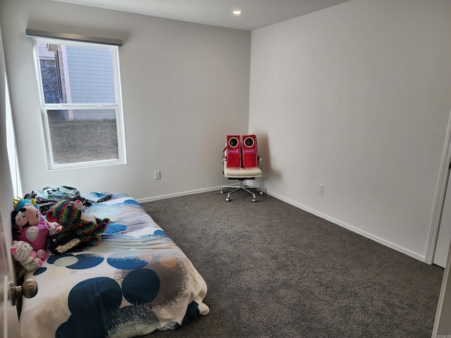 bedroom featuring multiple windows and dark carpet