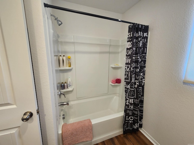 bathroom with hardwood / wood-style floors and shower / bathtub combination with curtain