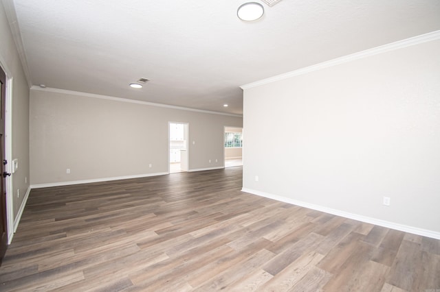 spare room featuring ornamental molding, a textured ceiling, and hardwood / wood-style flooring