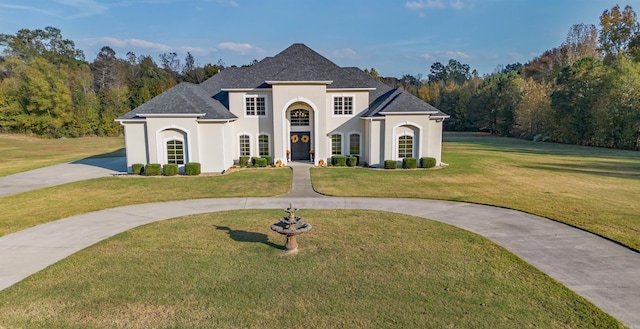 french provincial home featuring a front lawn