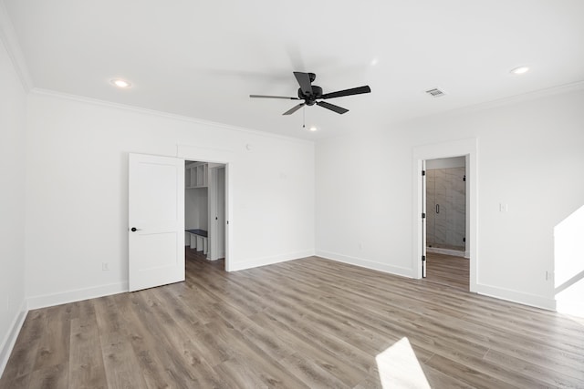 empty room with recessed lighting, baseboards, crown molding, and light wood finished floors