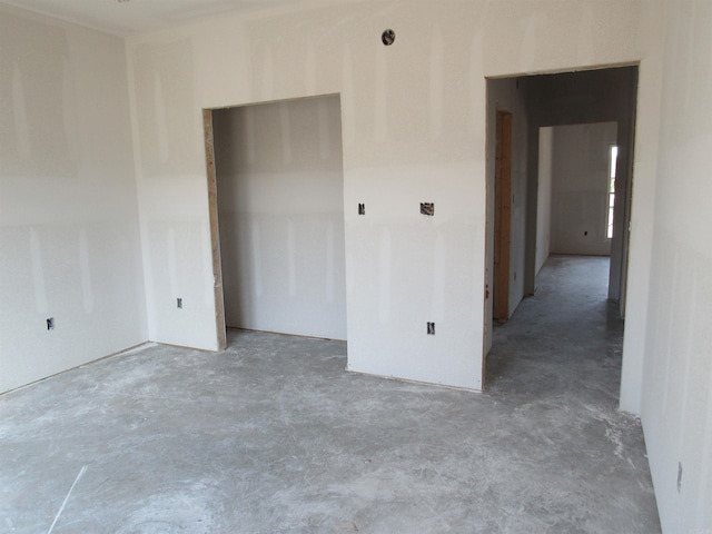 unfurnished bedroom with concrete floors