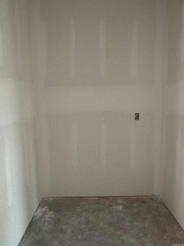 empty room with unfinished concrete flooring