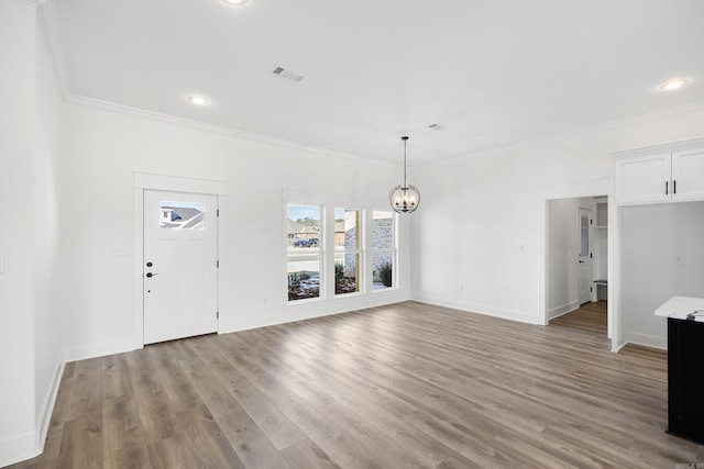 interior space with light wood-type flooring, crown molding, baseboards, and an inviting chandelier