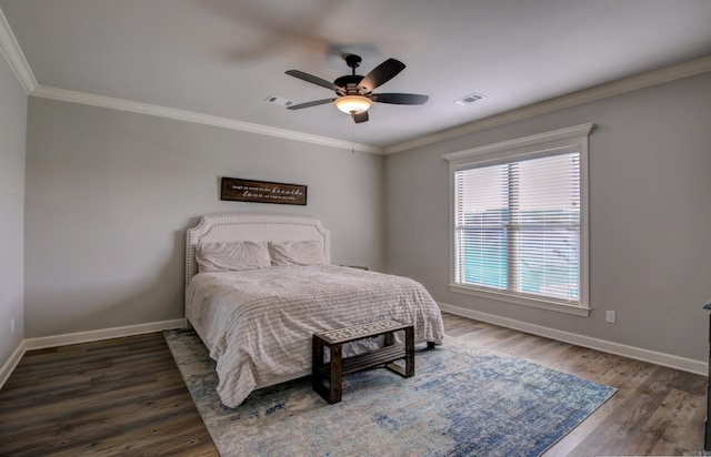 bedroom featuring ceiling fan, dark hardwood / wood-style floors, and ornamental molding