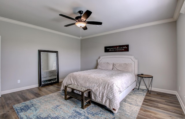 bedroom featuring ornamental molding, dark wood-type flooring, and ceiling fan