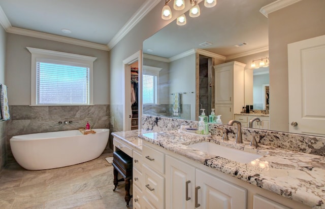 bathroom with vanity, plenty of natural light, crown molding, and tile walls