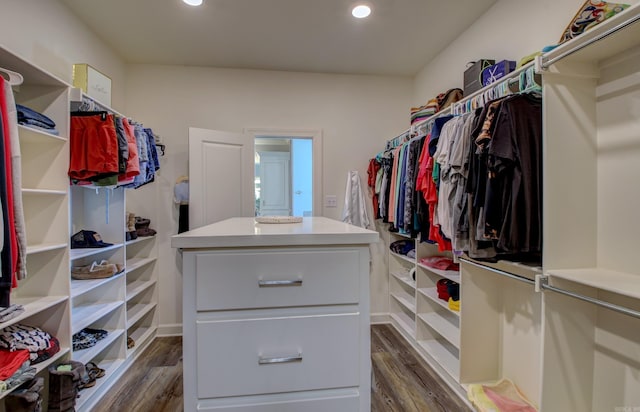 walk in closet with dark hardwood / wood-style flooring