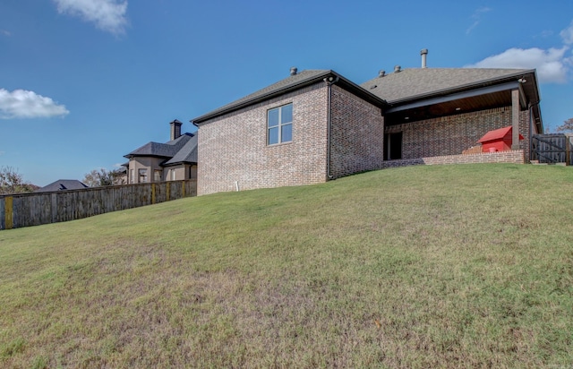 back of house with a lawn