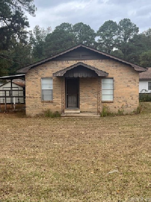 rear view of property with a yard