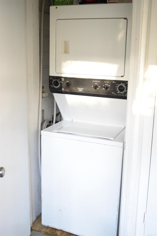 laundry room featuring stacked washer / drying machine