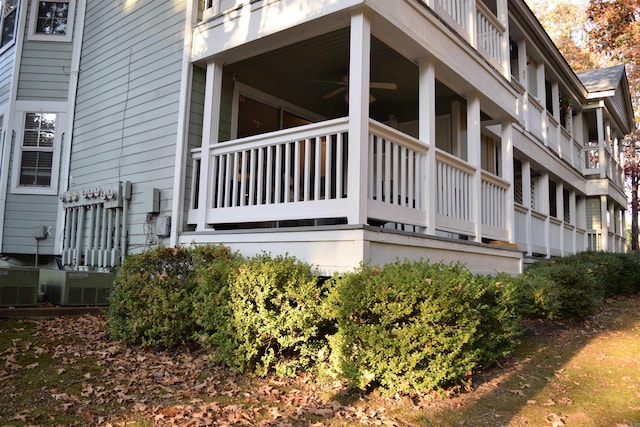 view of side of home with cooling unit and a balcony