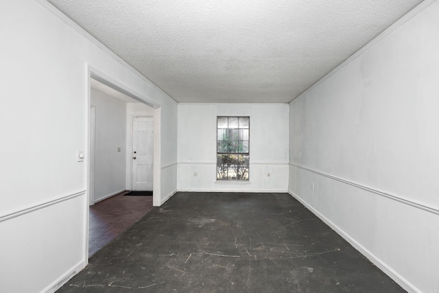 empty room featuring crown molding and a textured ceiling