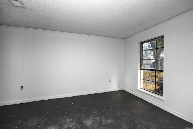 unfurnished room featuring a textured ceiling