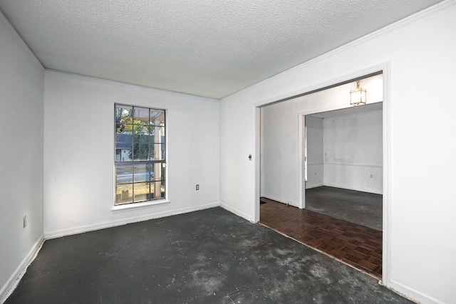 spare room with ornamental molding, a textured ceiling, and dark parquet flooring