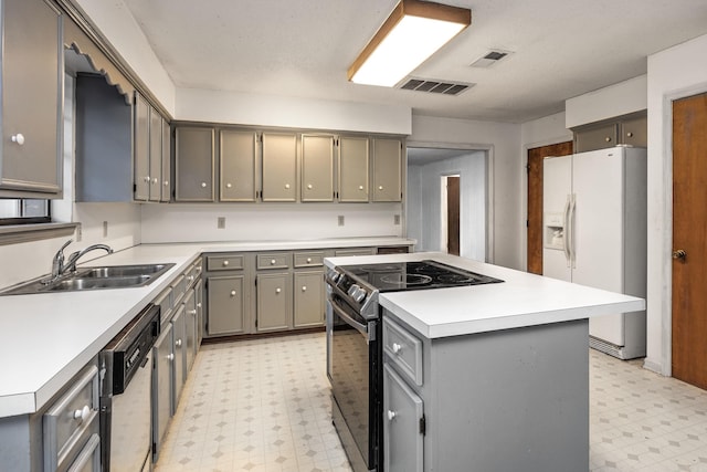 kitchen with white fridge with ice dispenser, sink, black range with electric stovetop, dishwasher, and a center island