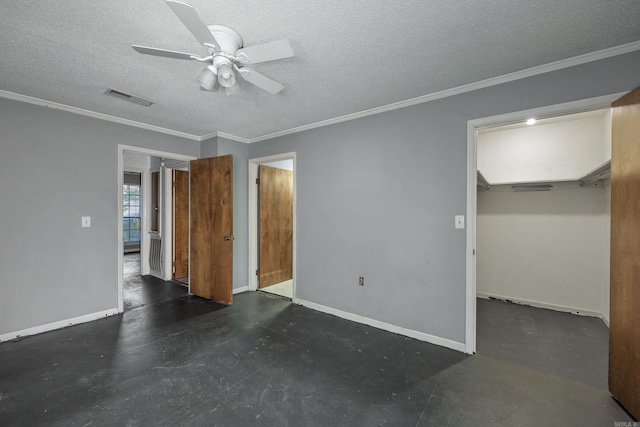 empty room with ornamental molding, a textured ceiling, and ceiling fan