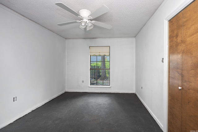 empty room featuring ceiling fan and a textured ceiling