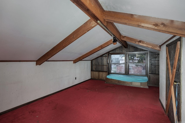 additional living space with lofted ceiling with beams and dark carpet