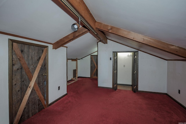 bonus room with lofted ceiling with beams and dark carpet