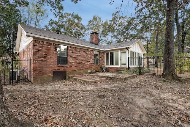 rear view of property with central air condition unit