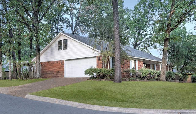 view of front of home with a front yard and a garage