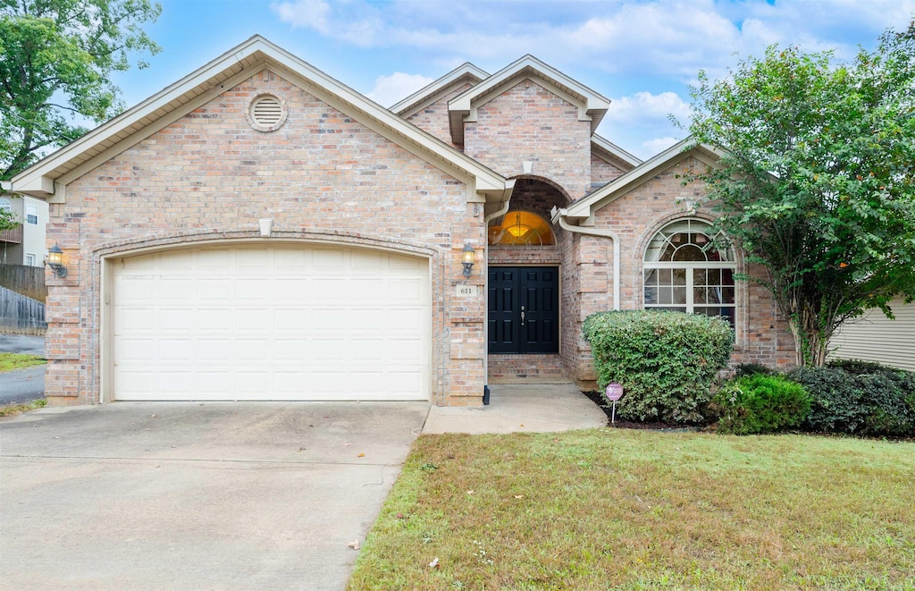 view of front of house with a front yard and a garage